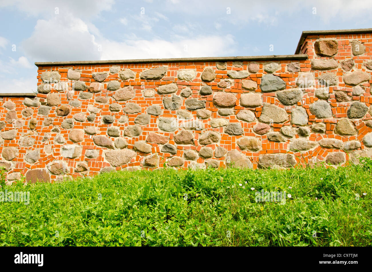Restored ancient wall made of red brick and stones Stock Photo Alamy