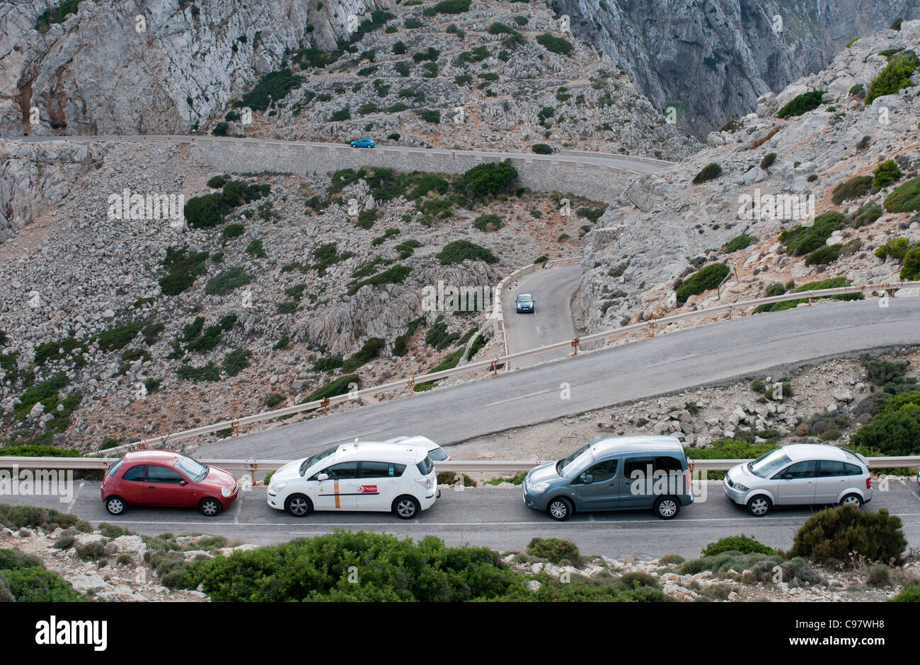 Cars parked on the narrow road leading to Formentor in the rugged north west of the holiday