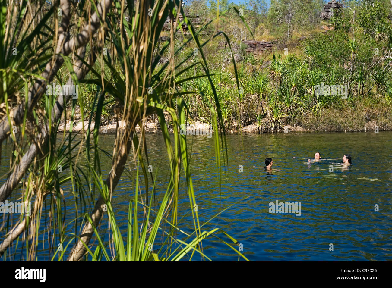 Tourists swim in a natural pool on the Jim Jim Falls Plateau. Kakadu