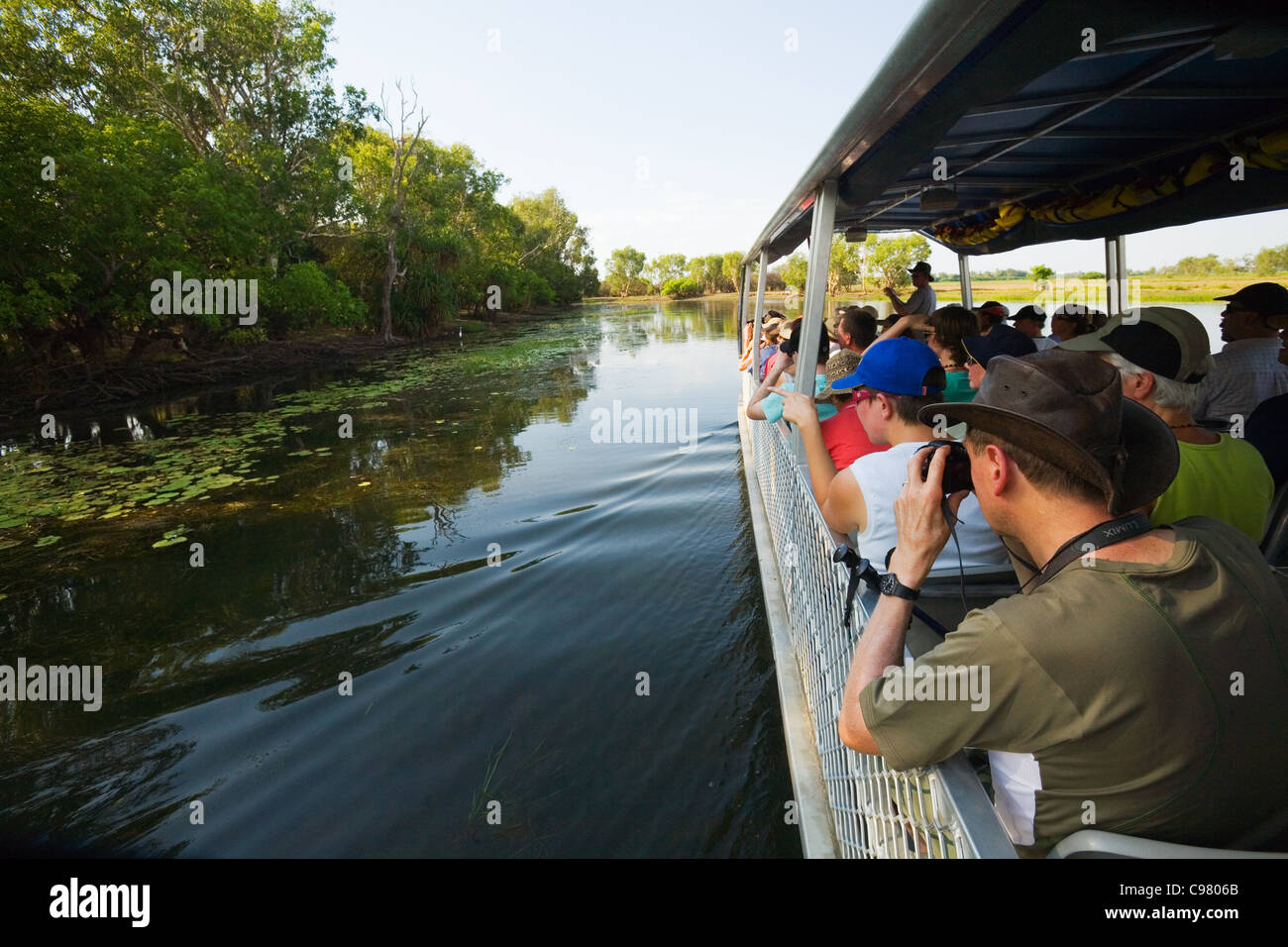 Visitors viewing wildlife on a Yellow Water Wetlands cruise. Cooinda, Kakadu National Park, Northern Territory, AUSTRALIA Stock Photo