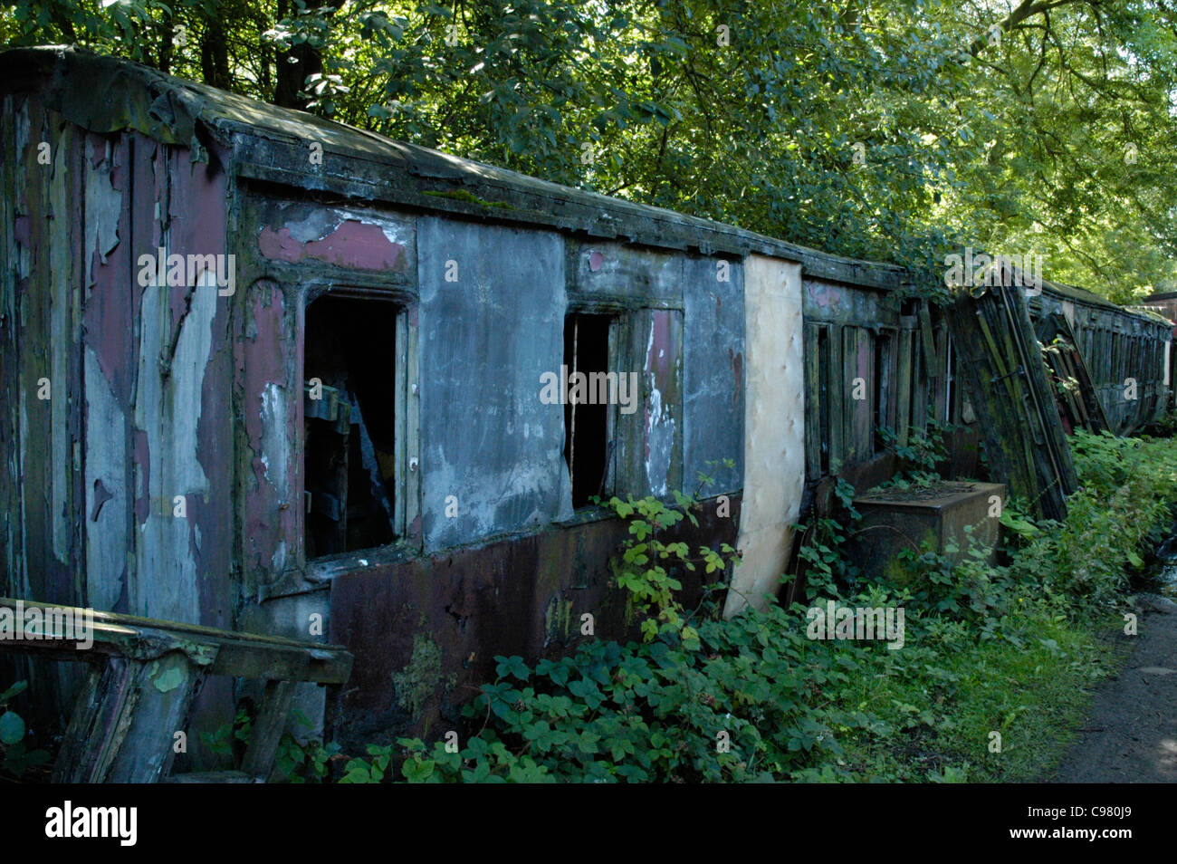 Derelict old carriages awaiting restoration on the Midland Railway heritage line, England, UK Stock Photo