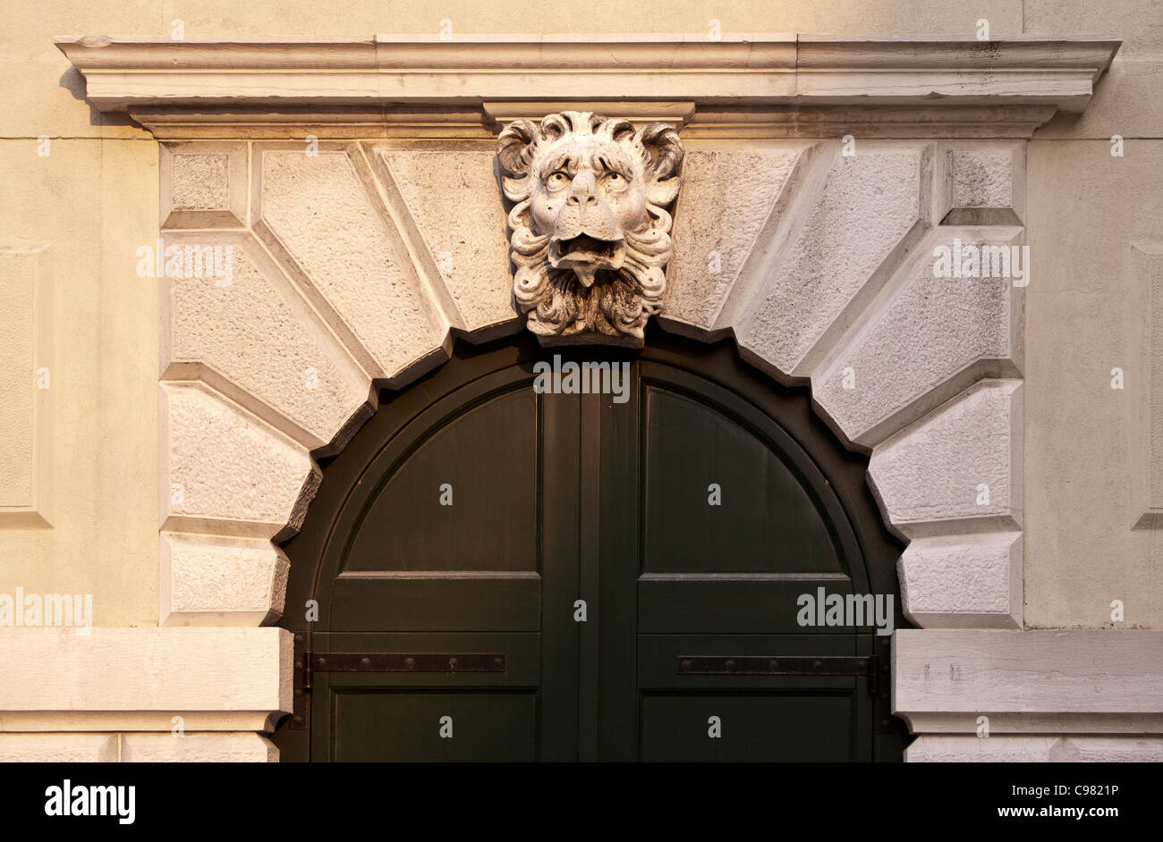 Stone arched doorway, with keystone in the form of a lion's head Stock Photo