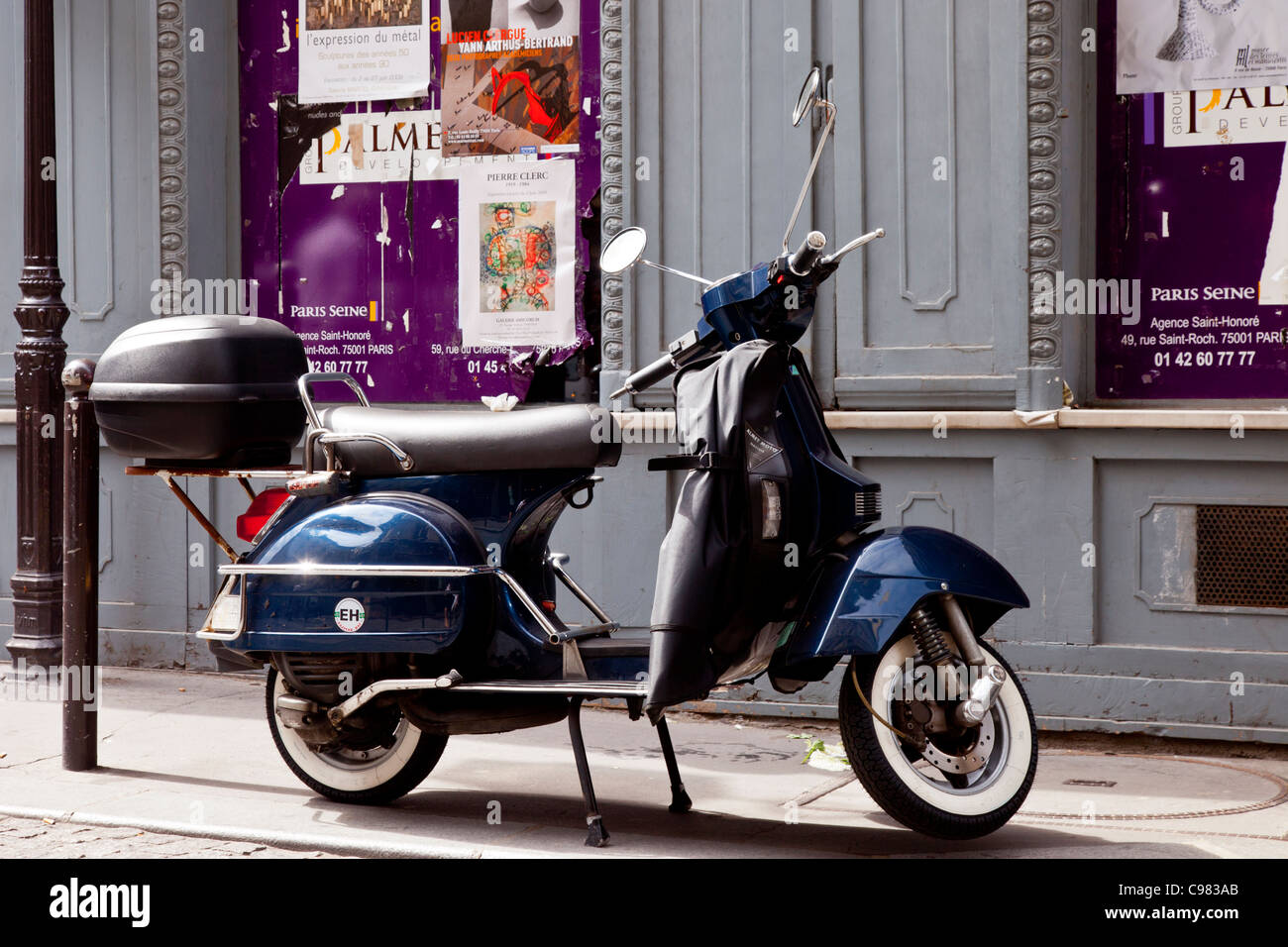 Motor Scooter parked on sidewalk in Paris, France Stock Photo