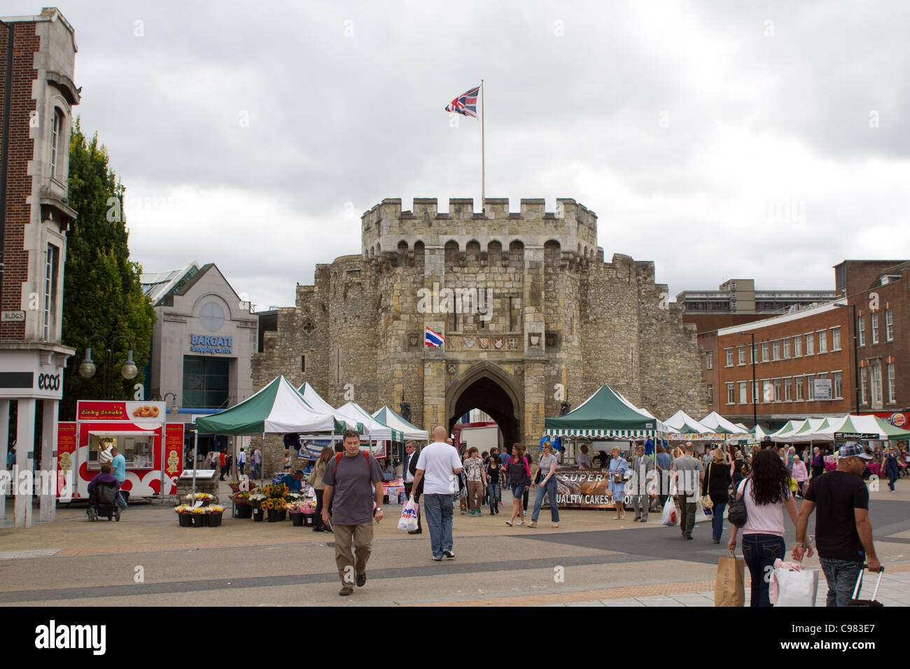 SOUTHAMPTON, UK - AUG 13: Crowd in pedestrian area of Southampton with historical Bargate in the background. Stock Photo