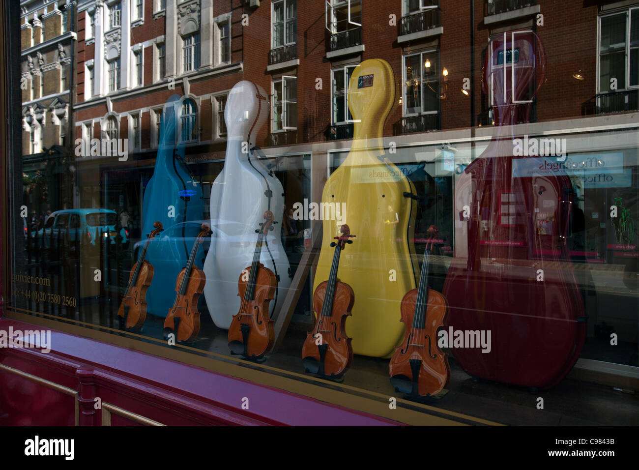 cellos and violins in the window of a london shop Stock Photo