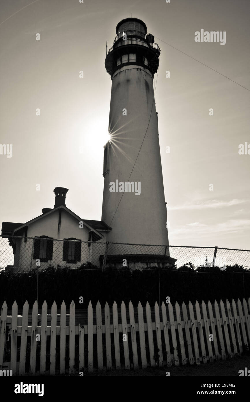 B&W of Pigeon Point Light Station, south of San Francisco, California, with sunburst, picket fence, lens-carriage and zip-line . Stock Photo