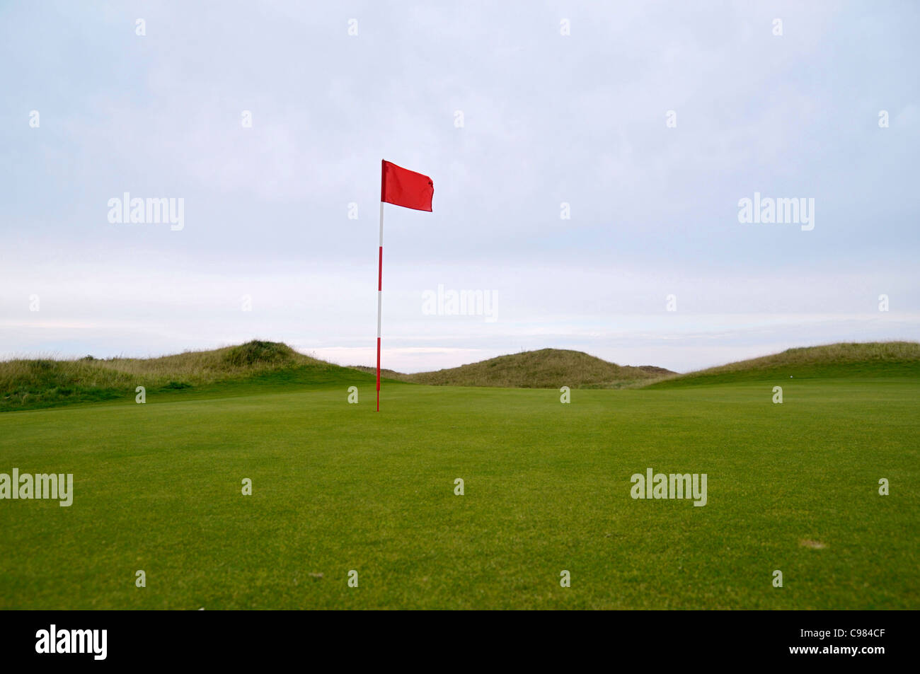 Red flag on the green, golf course Stock Photo Alamy