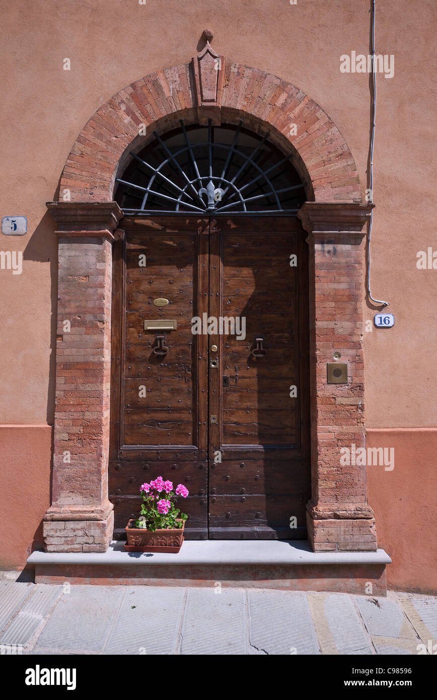 An arched brick doorway to a residence in Panicale, Italy. Stock Photo