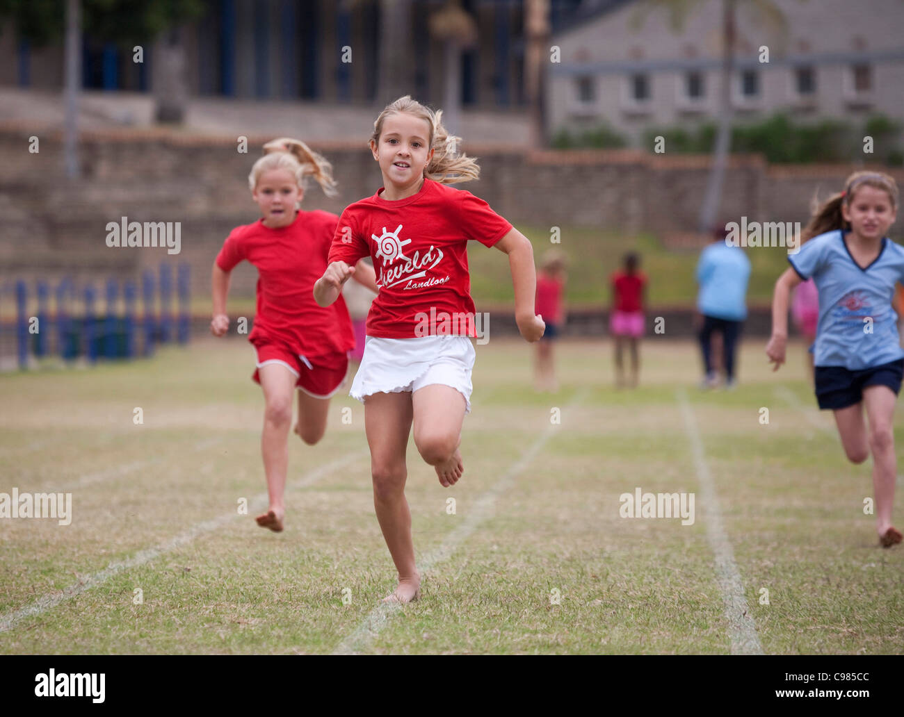 Primary school children running in interhouse athletics race Stock