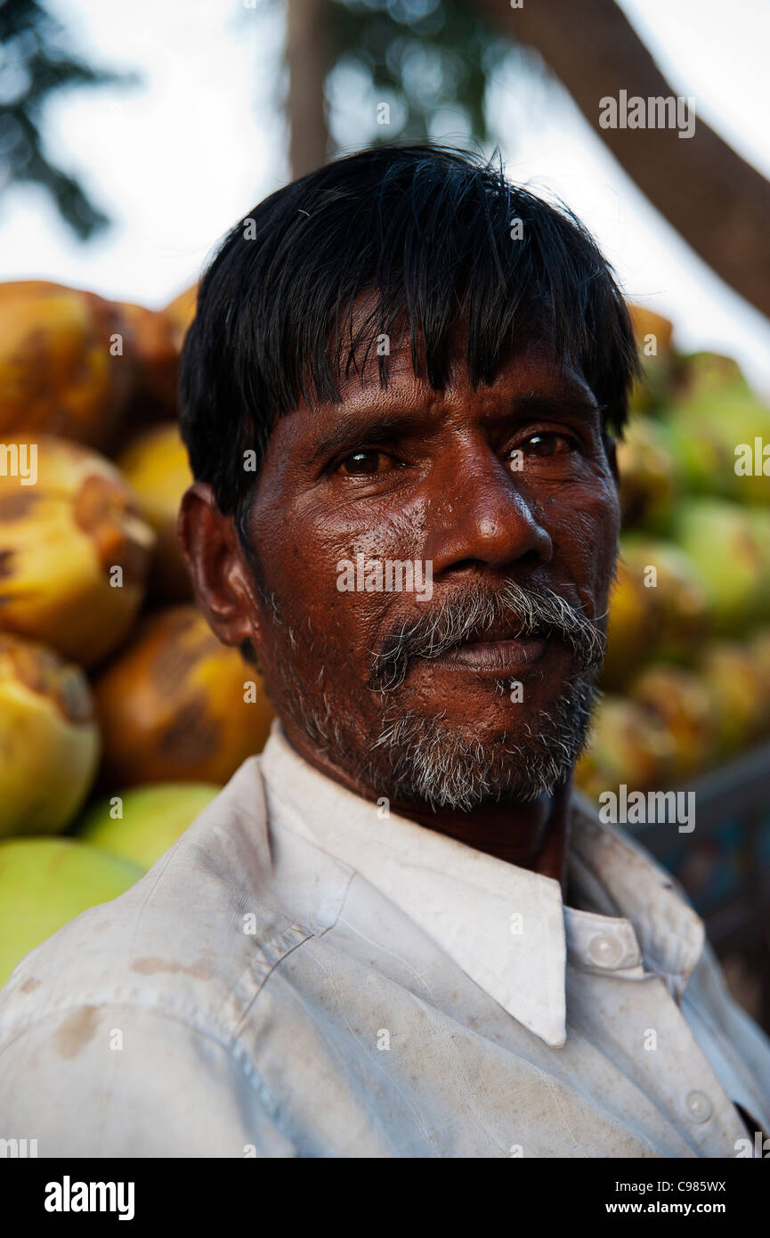 Coconut seller at the banks of Tungabhadra river in Hampi, Karnataka State, India Stock Photo