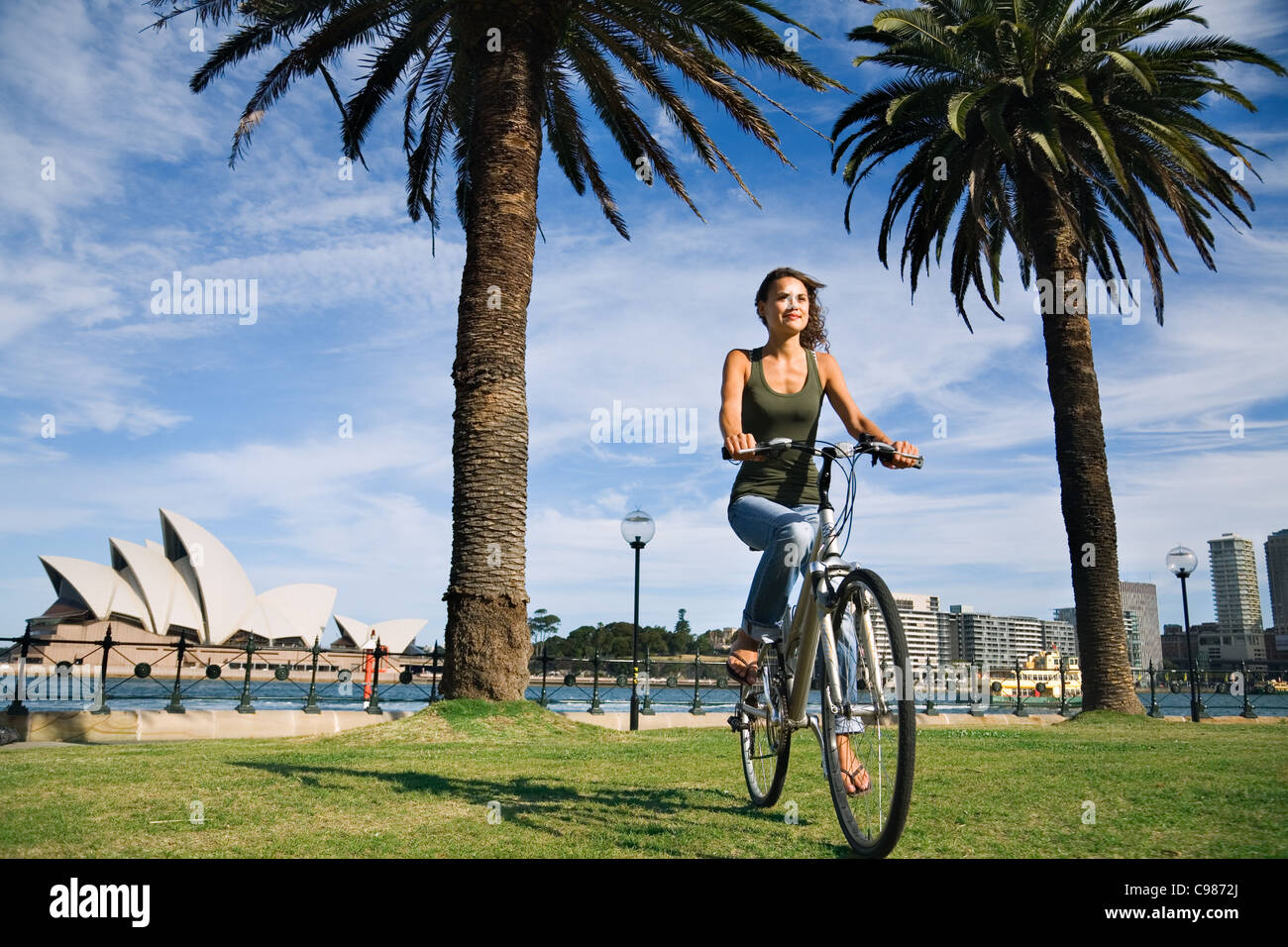 Woman riding bike at Dawes Point with Sydney Opera House in background.  Sydney, New South Wales, Australia Stock Photo - Alamy