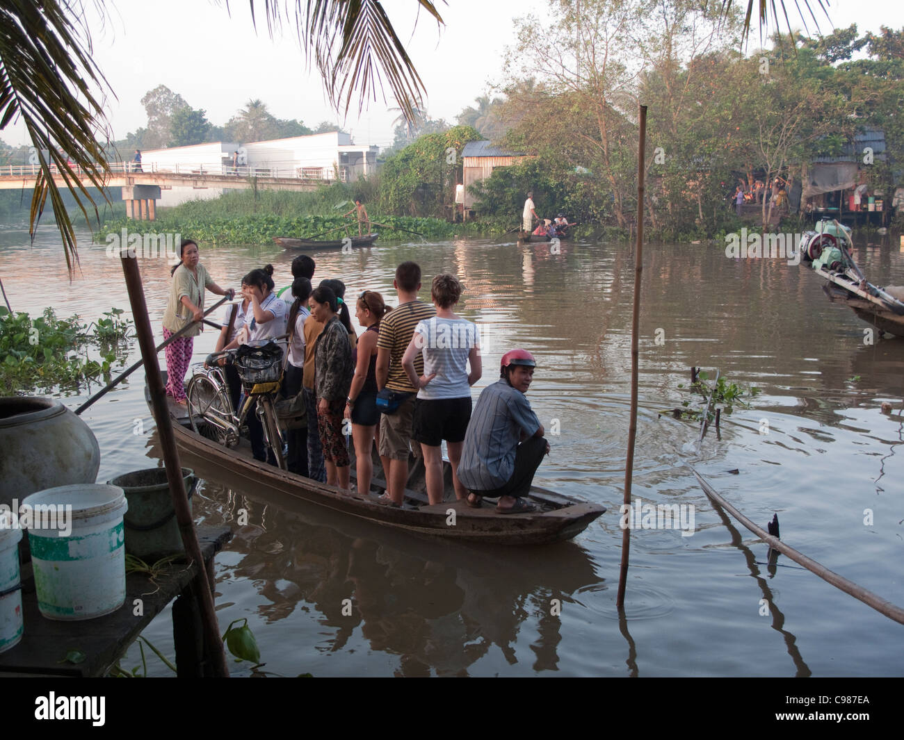 A water taxi filled with standing passengers in the Mekong Delta ...