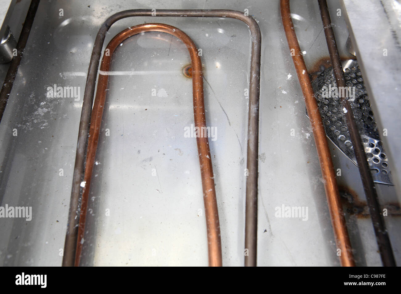 Immersion heater element in water Stock Photo