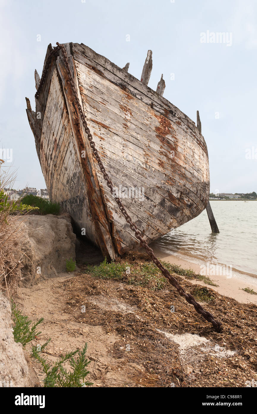 Old fishing boat wreck on side of marina left to the elements being ...