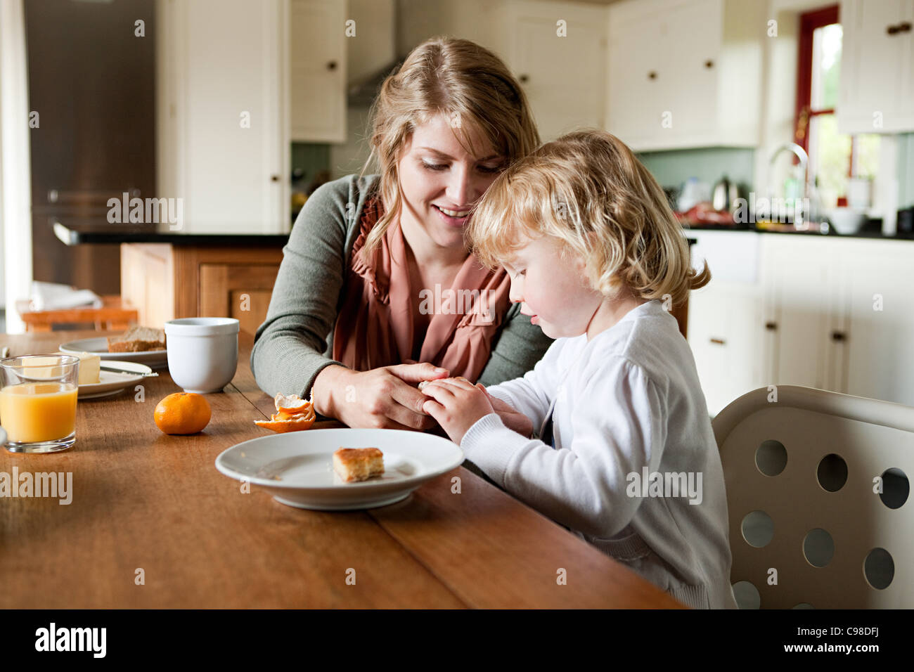 Mother and daughter having breakfast Stock Photo