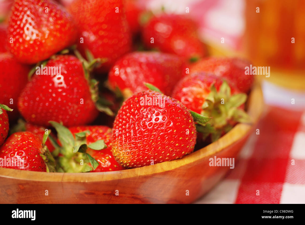 Wooden bowl full of fresh strawberries on a picnic table Stock Photo ...