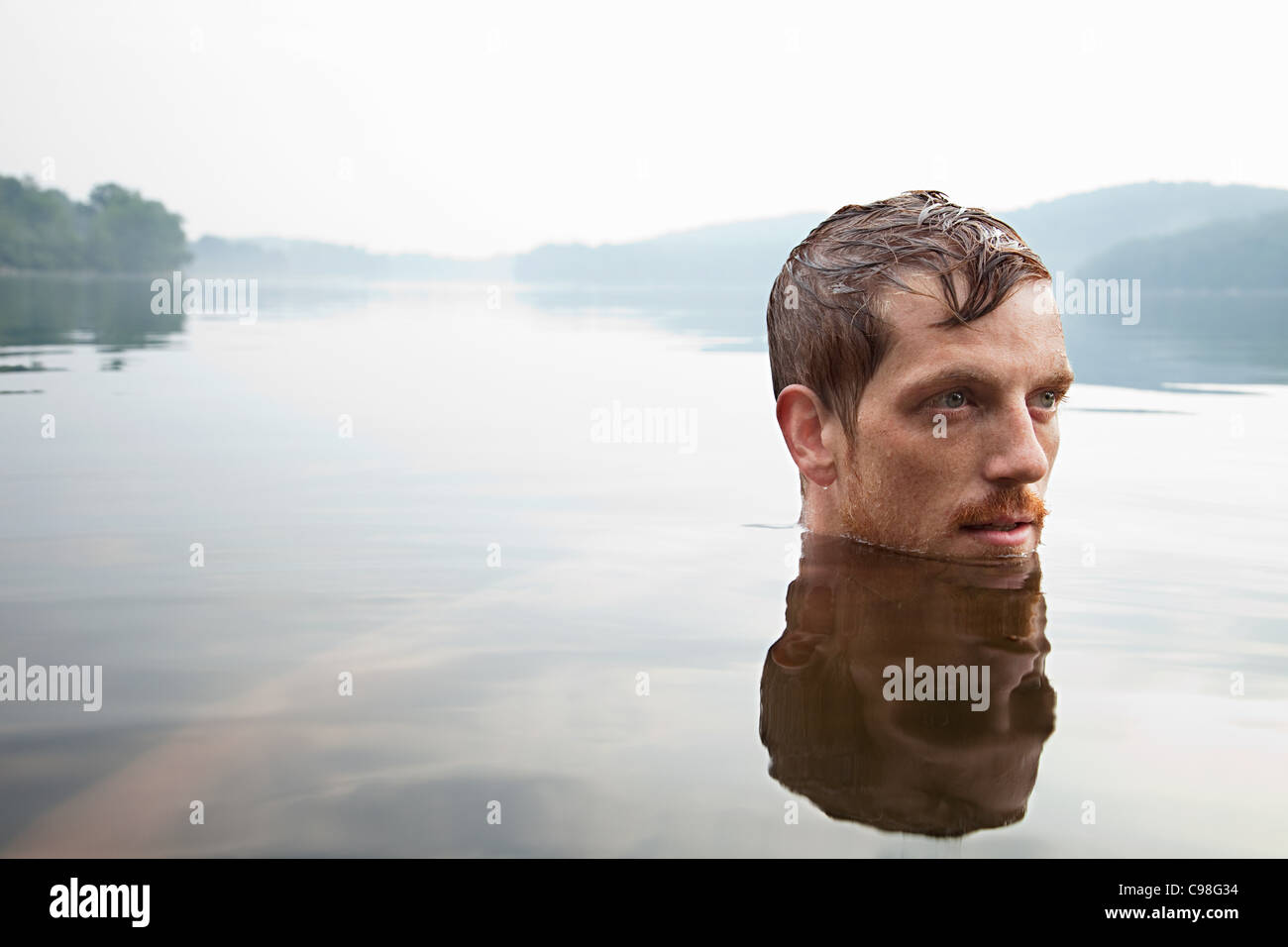 Mid adult man swimming lake Stock Photo