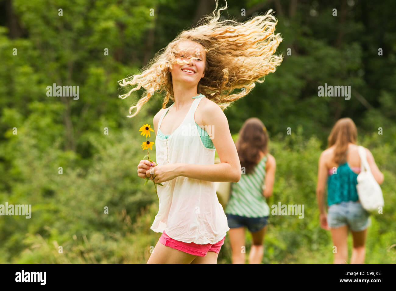 Teenage girl turning around and flicking hair Stock Photo
