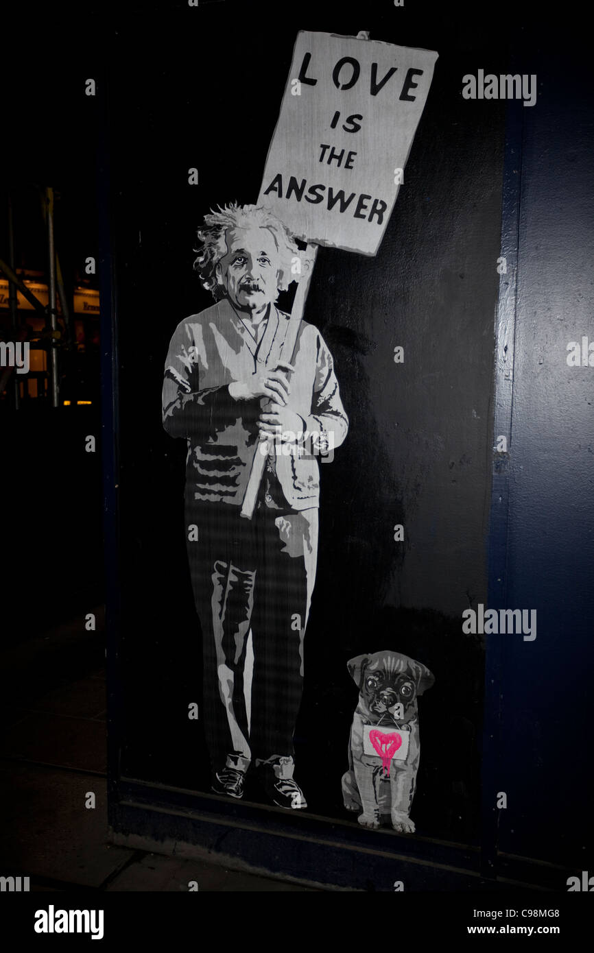 A street stencil graffiti of Albert Einstein holding a sign which reads ,Love is the Answer', London, England, UK. Stock Photo