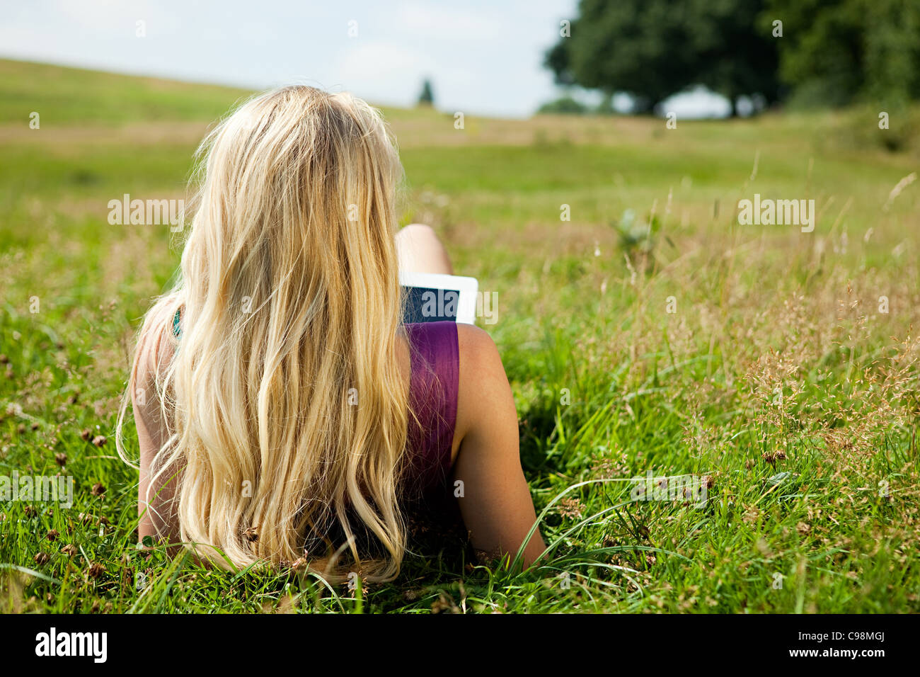Young woman using handheld computer device field Stock Photo Alamy