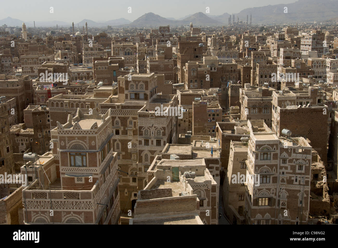 Looking across the rooftops of Old City of Sana'a, showing ancient multiple-storey tower houses, Sana'a, Yemen Stock Photo