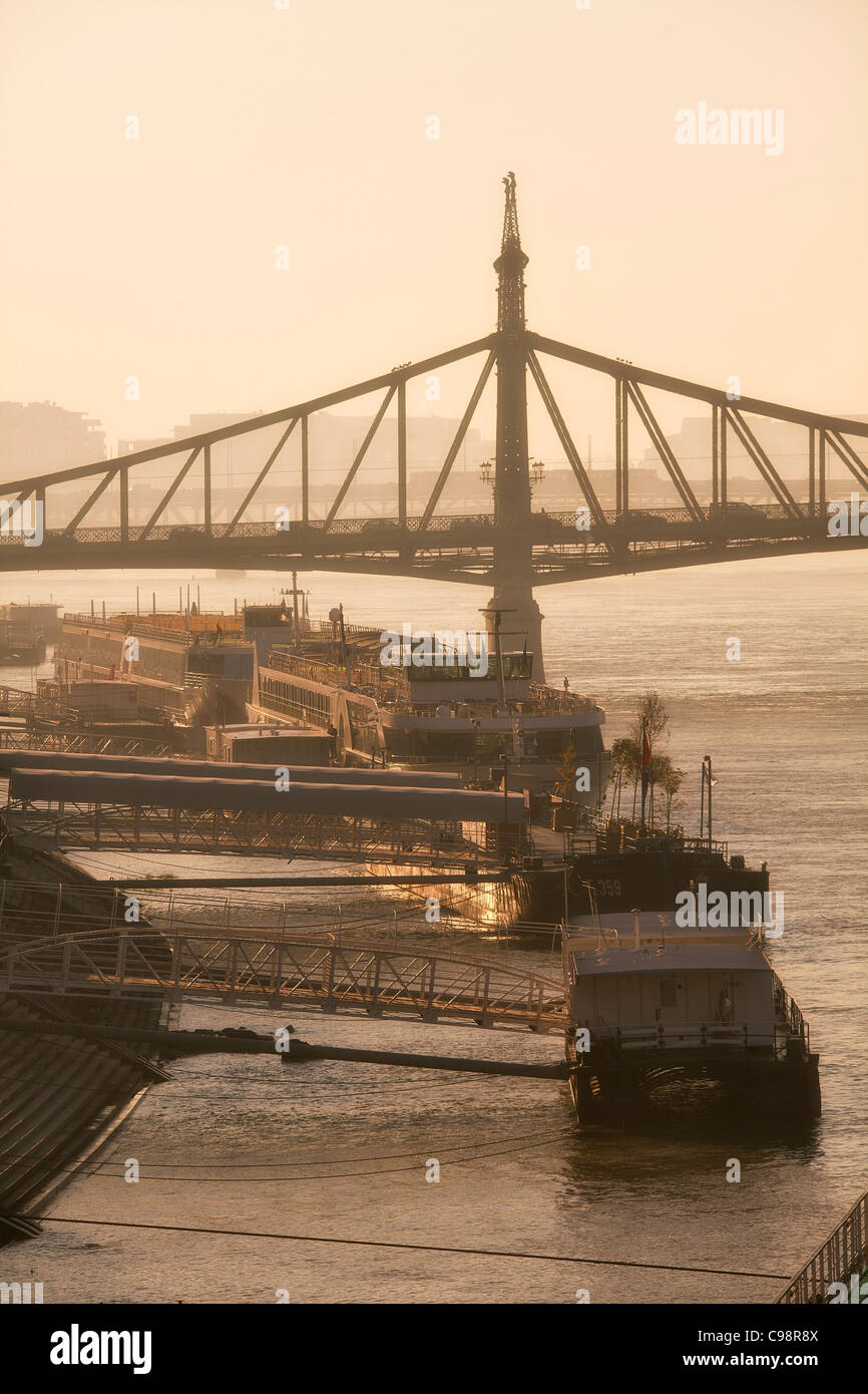 Budapest, Quayside on Danube River and Freedom Bridge at Sunrise Stock Photo