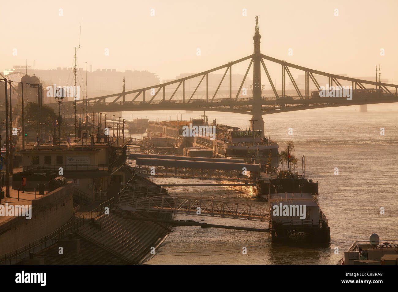 Budapest, Quayside on Danube River and Freedom Bridge at Sunrise Stock Photo