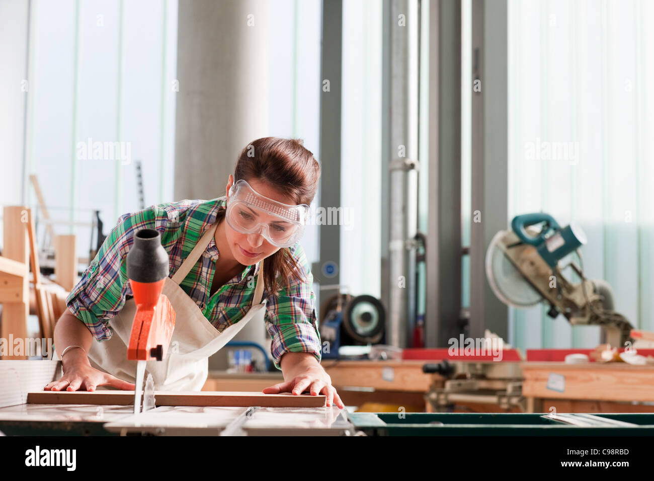 Carpenter using saw workshop Stock Photo - Alamy