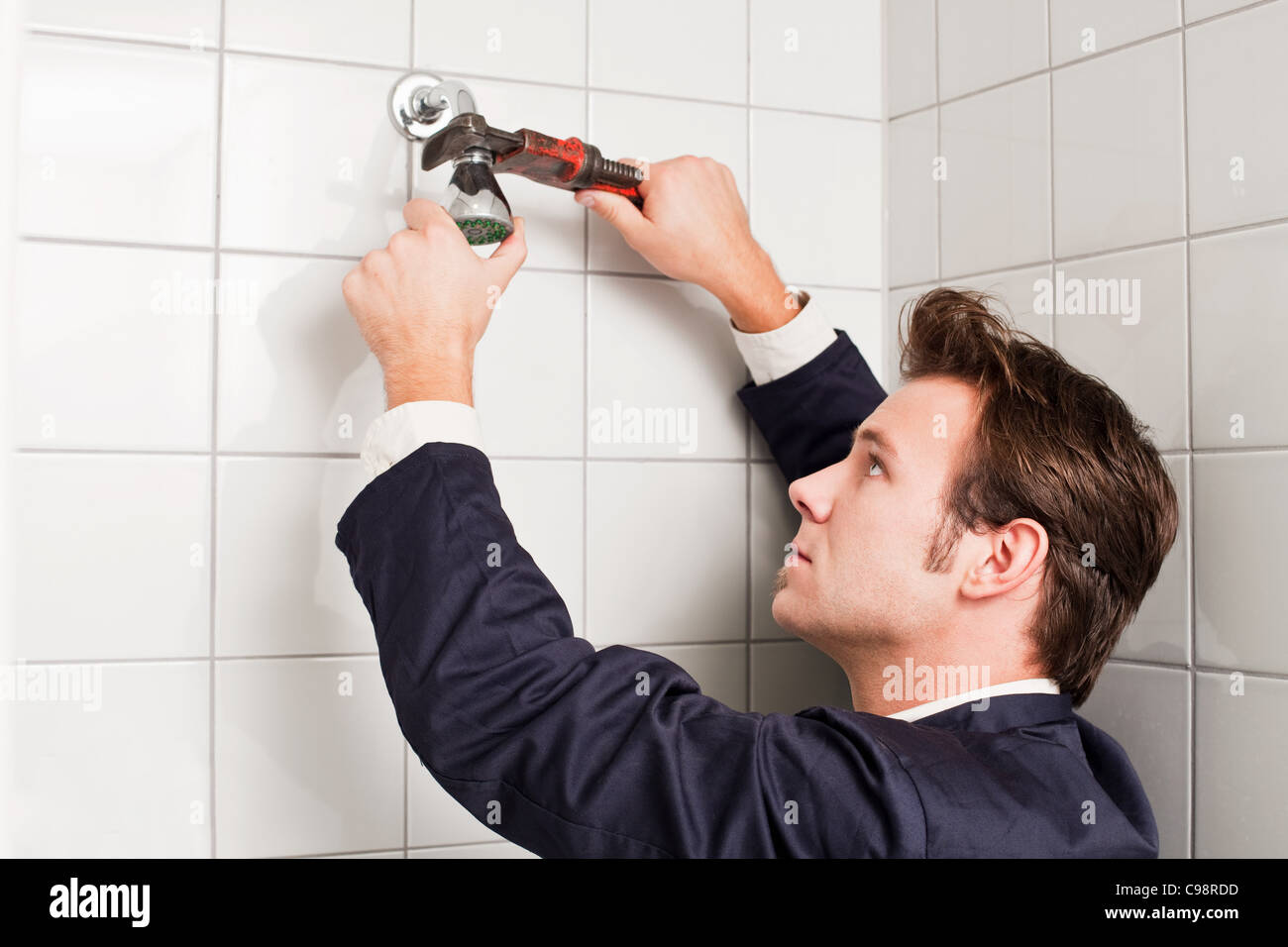 Plumber fixing shower head Stock Photo Alamy