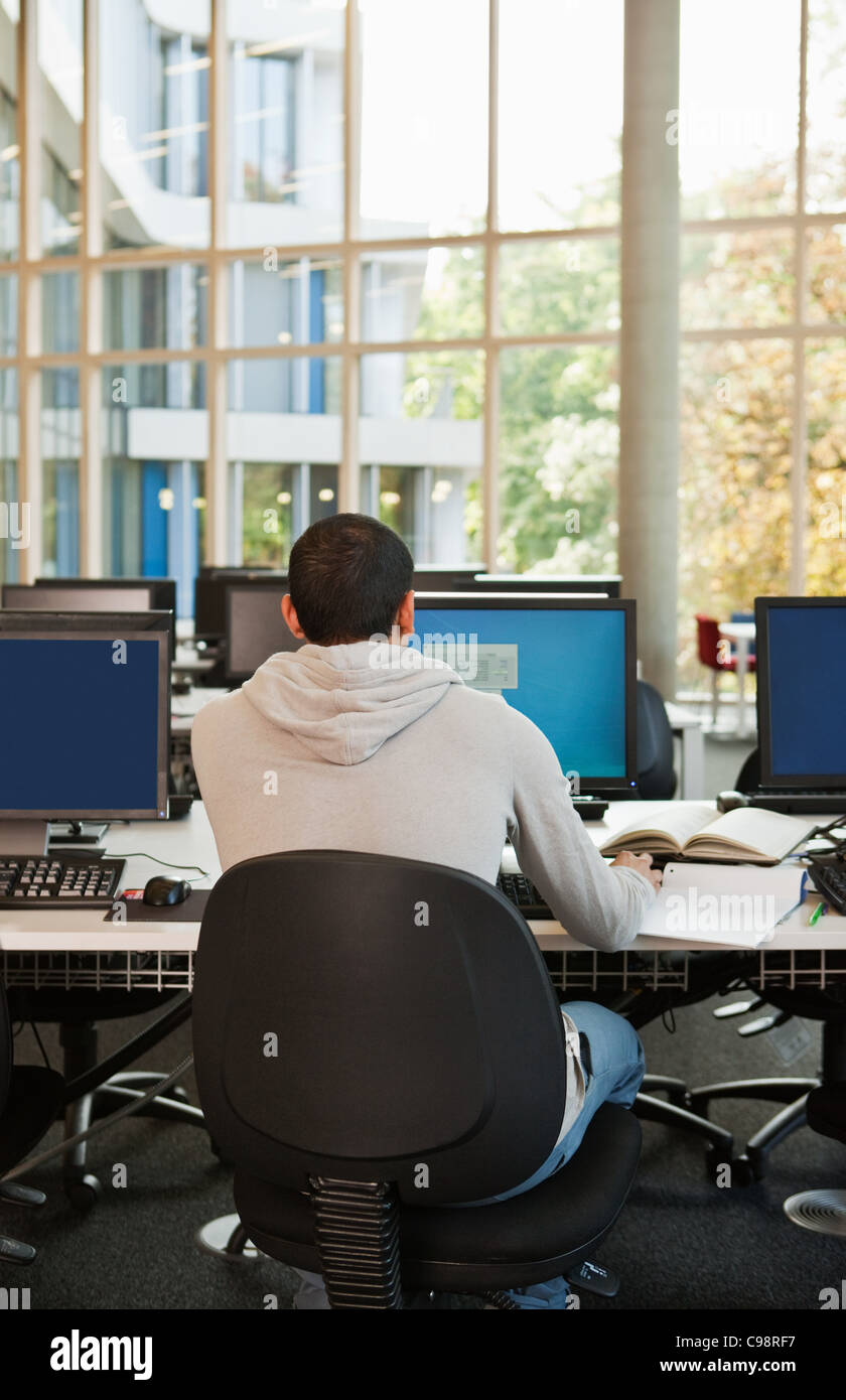 University Student Working Computer Desk Rear View Stock Photo