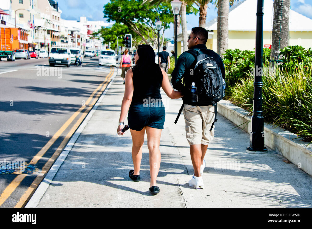 Young couple walking down the street holding hands Stock Photo - Alamy
