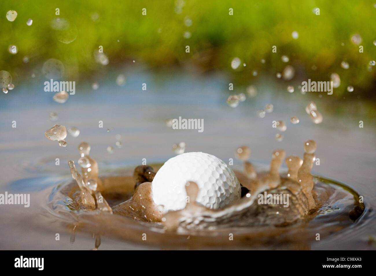 Golf ball splashing into water Stock Photo Alamy