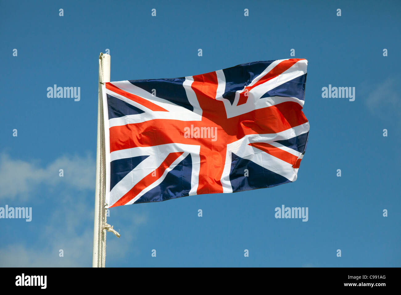 Union Jack flying against a blue sky Stock Photo