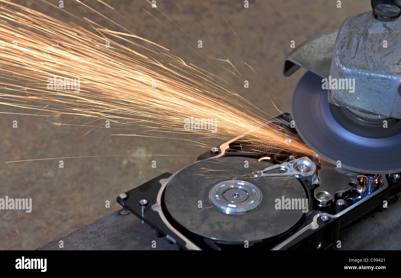 hard disk drive with rotating grinder and sparks in front of rusty back