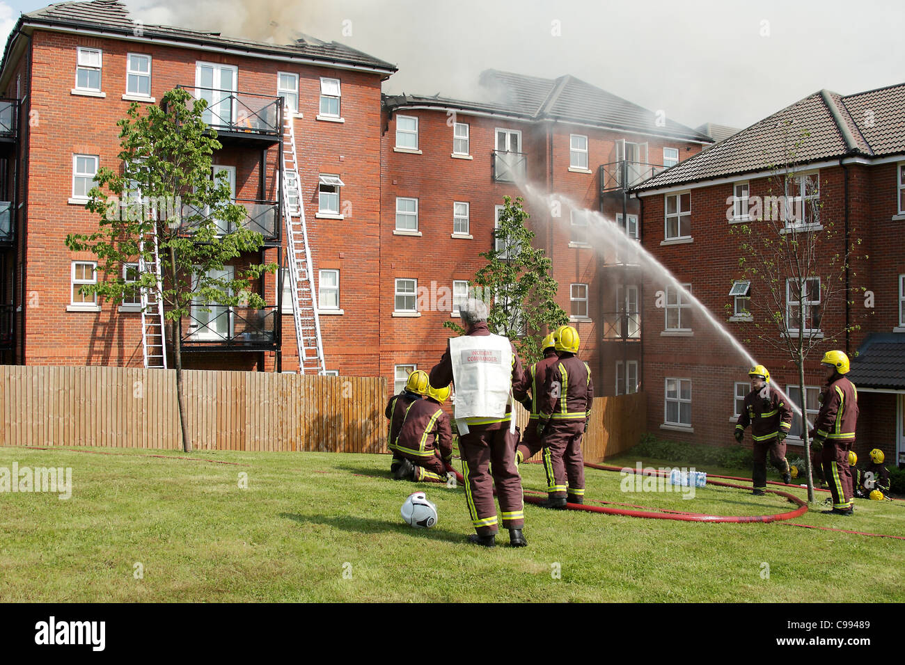 Firemen tackle a fire in a residential property in Ilford, London. Stock Photo