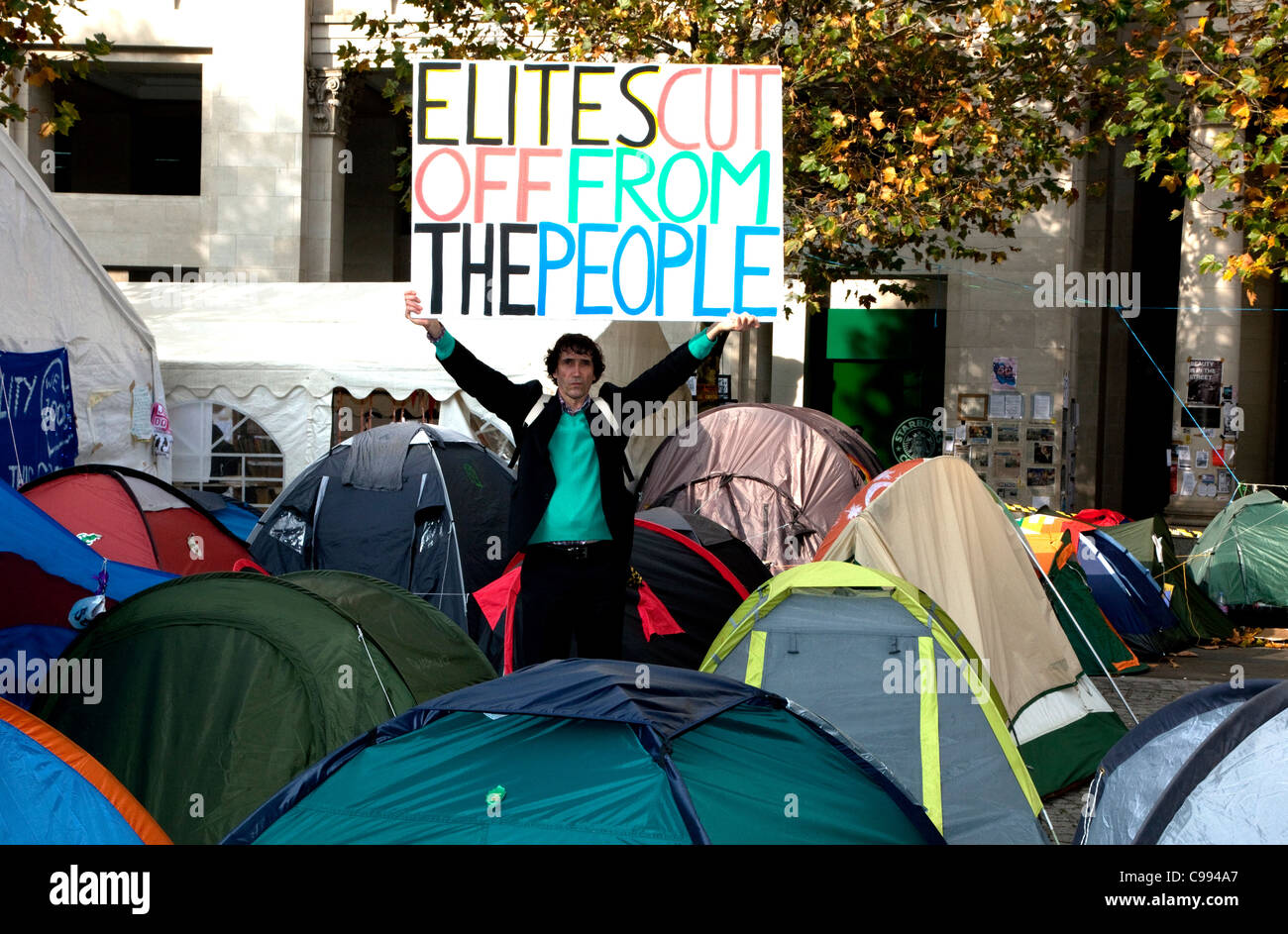 French activist and author Jean-Baptists Redde aka Voltuan with banner in Occupy London camp outside St Paul's Cathedral, London Stock Photo