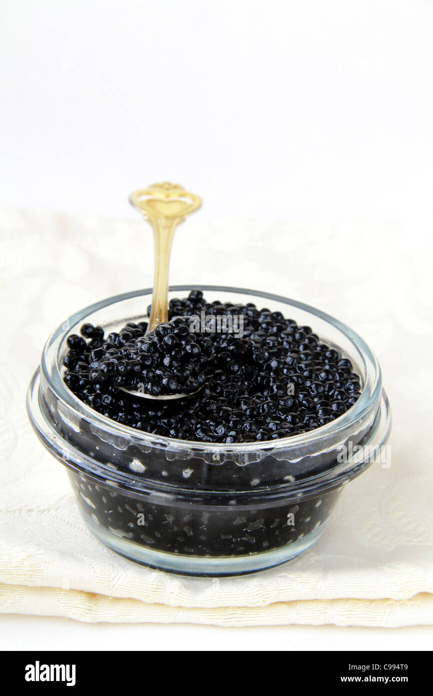 Black caviar in a glass jar on a white background Stock Photo