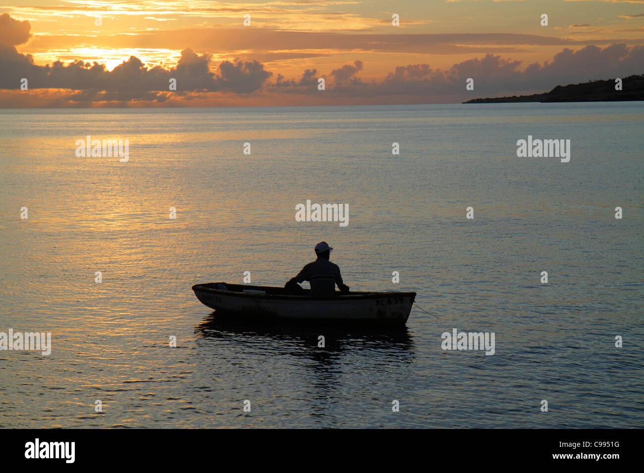 Curaçao,Netherlands Lesser Leeward Antilles,ABC Islands,Dutch,Piscadera Bay water,Caribbean Sea water rowboat,man men male adult adults,sunset,calm oc Stock Photo