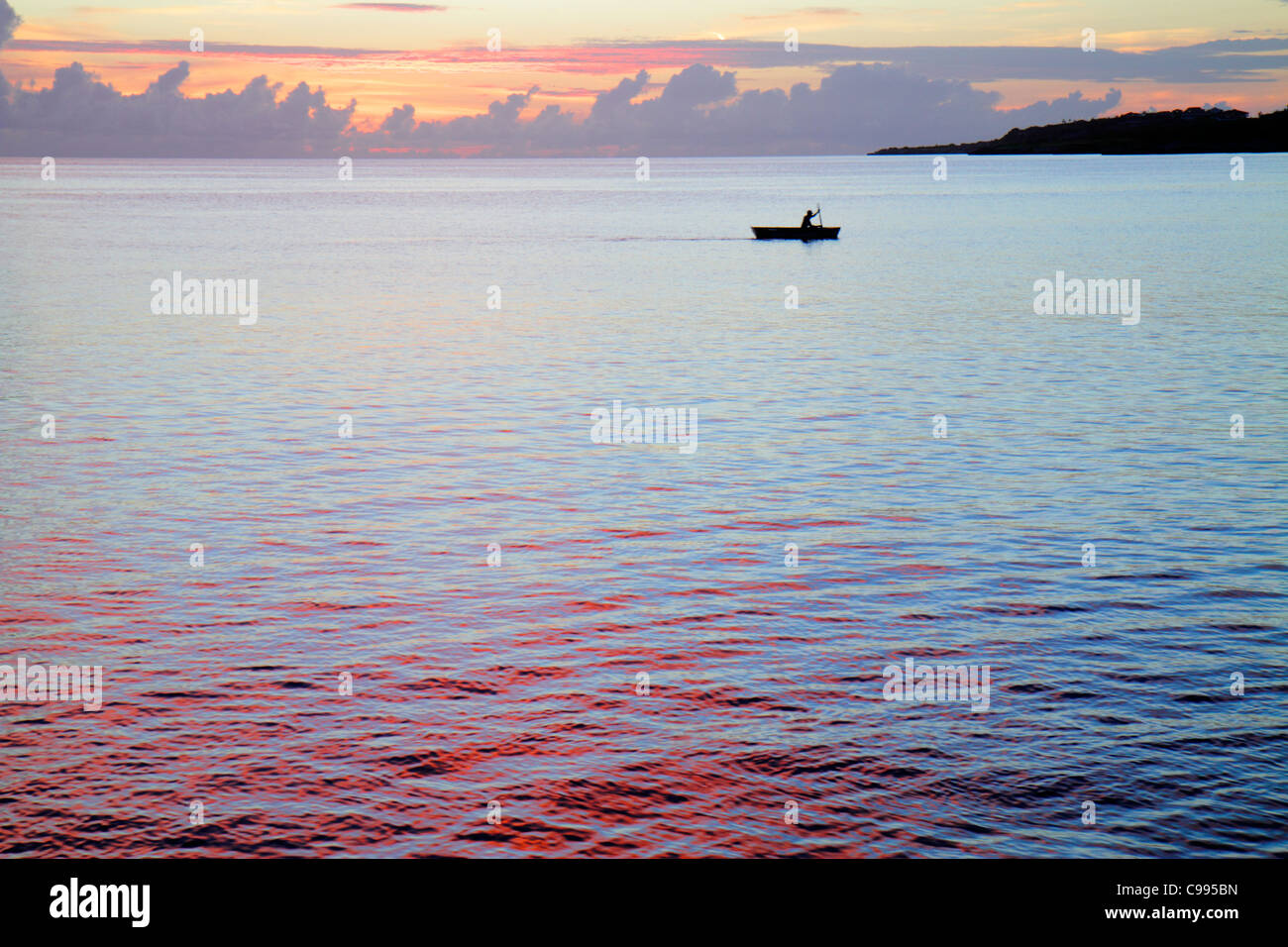 Curaçao,Netherlands Lesser Leeward Antilles,ABC Islands,Dutch,Piscadera Bay,Caribbean Sea,water,rowboat,man men male adult adults,sunset,twilight,calm Stock Photo