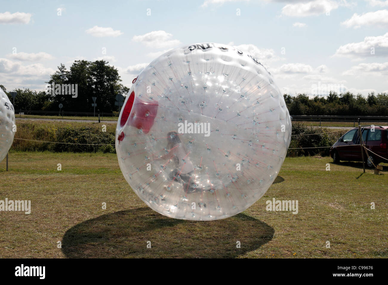 Children zorbing (riding in Zorbs (sorbs)) at the 2011 War & Peace Show at Hop Farm, Paddock Wood, Kent, UK. Stock Photo