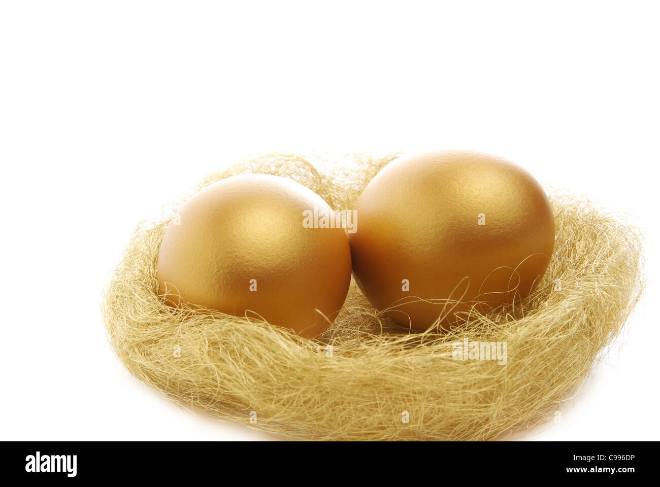 two golden eggs in the nest isolated on a white background Stock Photo ...