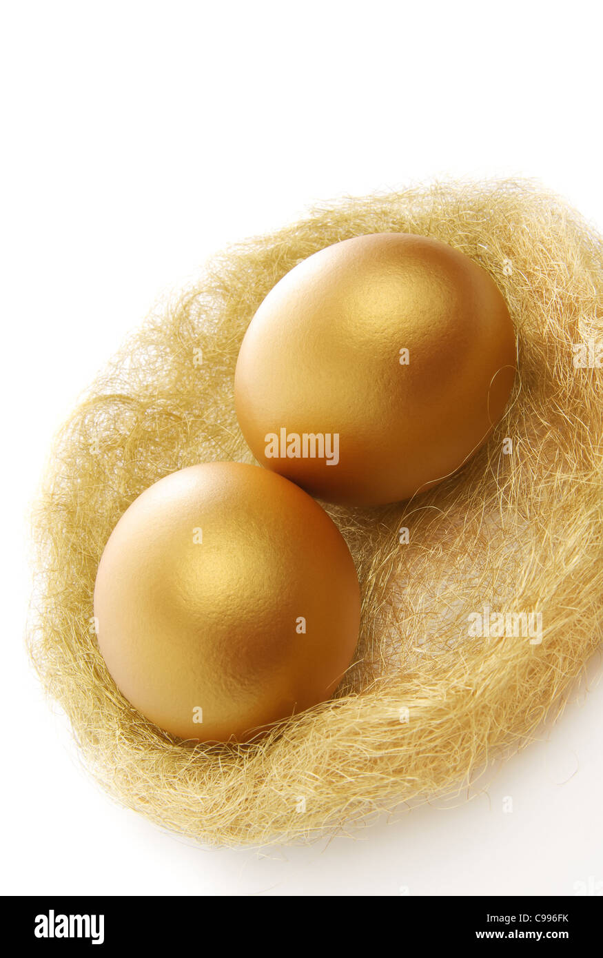 two golden eggs in the nest isolated on a white background Stock Photo ...