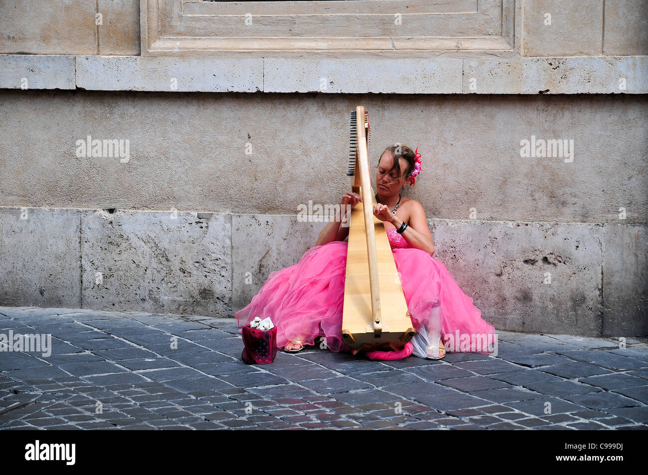 Rome, Italy Street performer Harpist in pink Stock Photo