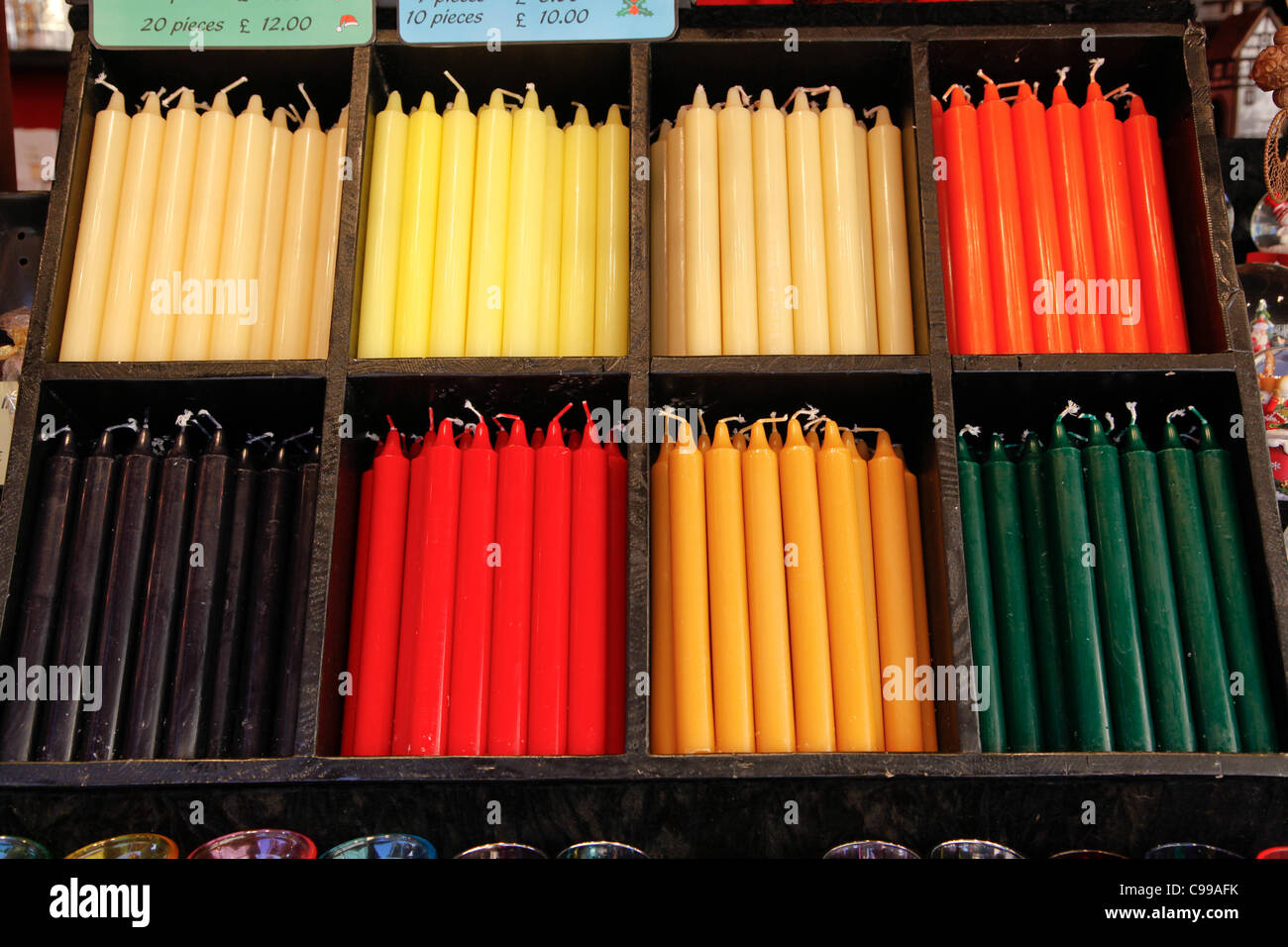 Coloured candles in wooden display at the Birmingham German Market