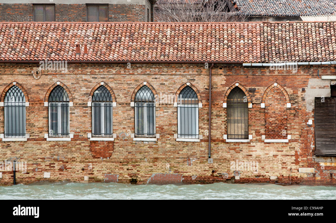 Glass factory at Murano with Gothic arched windows ands a tiled roof ...