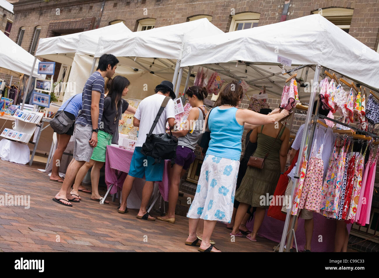 Tourists browse stalls at The Rocks Market.  Sydney, New South Wales, Australia Stock Photo