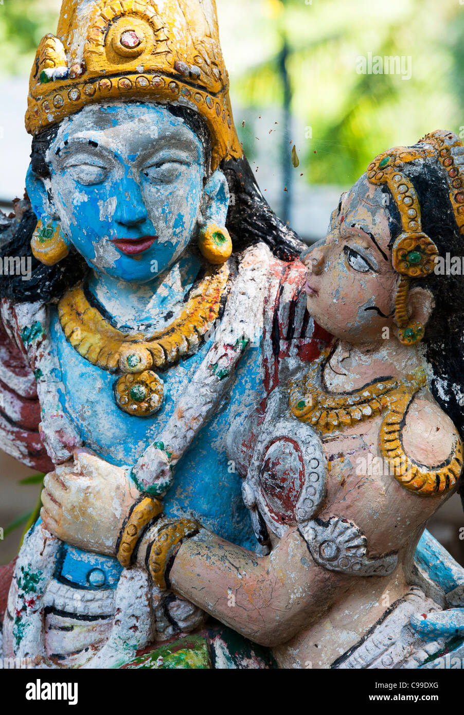 Old worn out Krishna and Radha painted indian statues. India Stock Photo