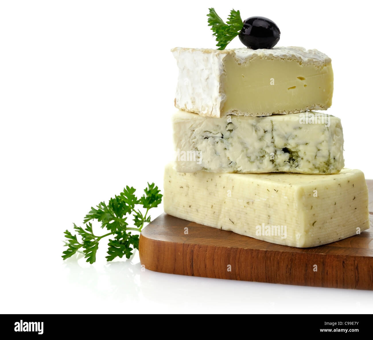 A Stack Of Different Kinds Of Cheese On A Cutting Board Stock Photo