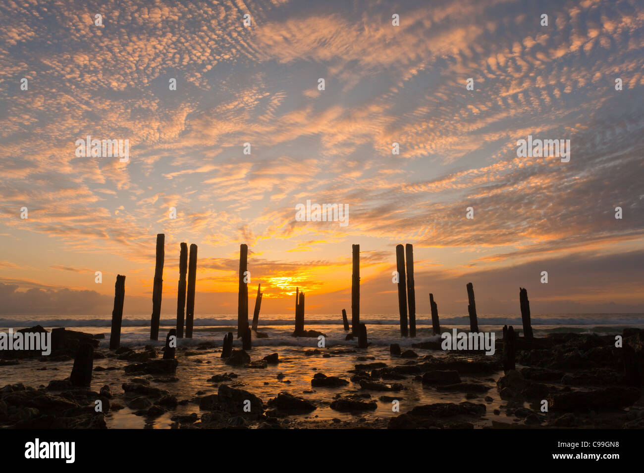 Cirrus clouds at sunset over the ruins of Port Willunga Jetty in Adelaide's southern suburbs Stock Photo