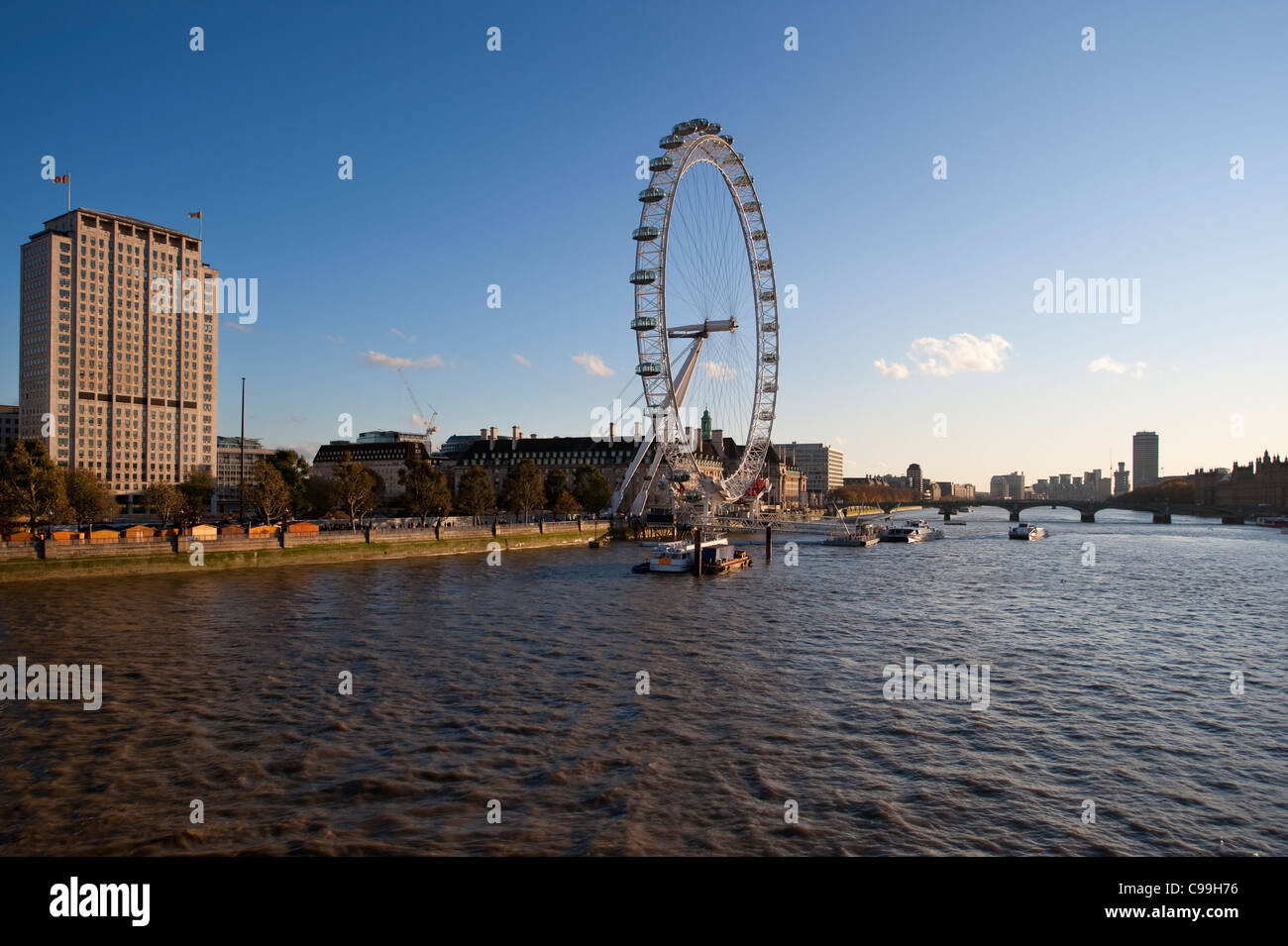 The iconic London Eye and Shell Centre building on the south bank of the river Thames in Autumn evening sunlight. Stock Photo